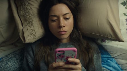 a woman in bed on her phone