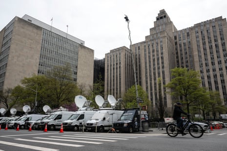 Media vehicles are parked outside of the Manhattan criminal court building as former US president Donald Trump attends his trial for allegedly covering up hush money payments linked to extramarital affairs, in New York City on April 19, 2024.