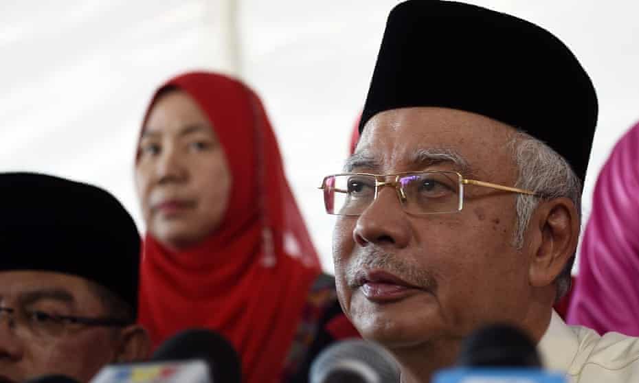 Najib Razak addresses the media at a mosque on the outskirts of Kuala Lumpur on July 5, 2015. He is threatening to sue the Wall Street Journal.