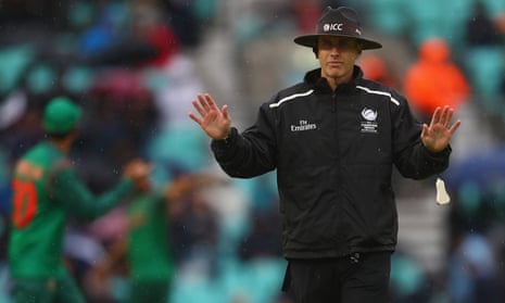 Match umpire Chris Gaffaney calls a halt to play as rain comes down at the Oval.