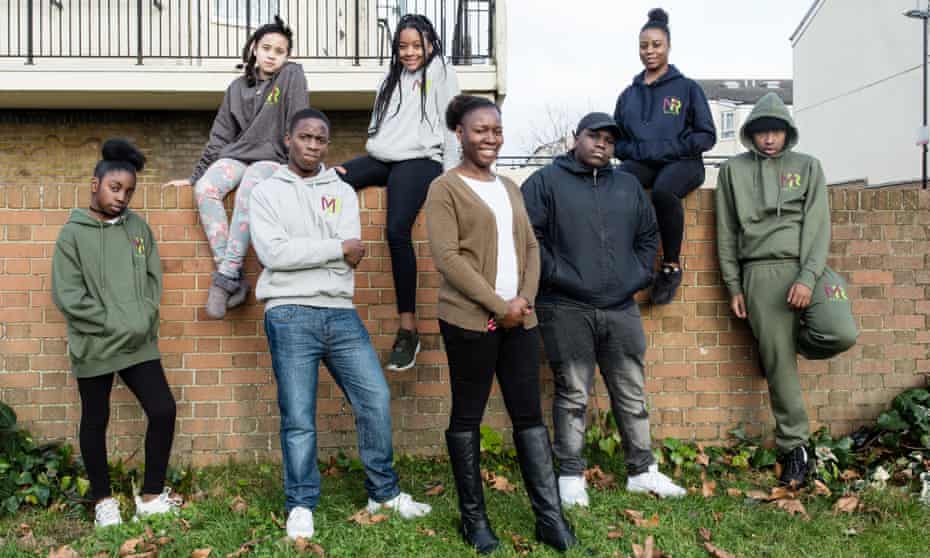 Magdalene Adenaike, founder of the Music Relief Foundation, and teenagers in Croydon