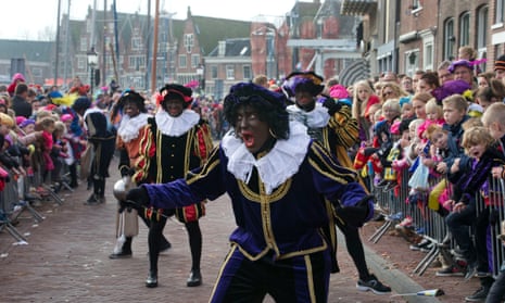 “Black Pete” jokes with children after arriving with Sinterklaas in Hoorn.