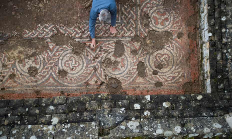 An archaeologist works on the mosaic at Chedworth Roman villa.