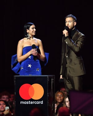 Dua Lipa and Calvin Harris accept the Brit award for best British single.