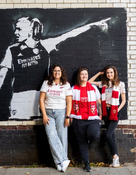Arsenal Women football fans (from left) Jemma, Hollie and Bonnie, in front of graffiti art of vice-captain Leah Williamson in a tunnel near the Emirates stadium