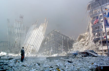 a man stands in the rubble of the World Trade Center