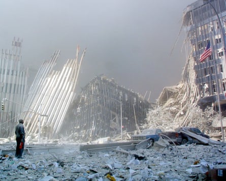 A man stands in the rubble on 9/11.