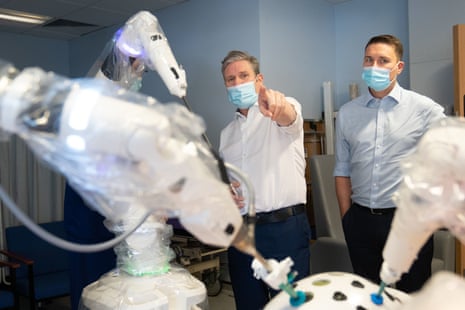 Keir Starmer and Wes Streeting inspecting a robot that is capable of surgical procedures on patients, during their visit to the Lister Hospital in Stevenage.