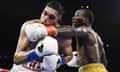 Terence Crawford, right, punches Amir Khan during the fifth round of their WBO world welterweight championship boxing match.