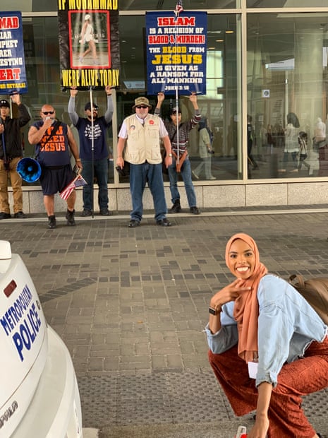 Shamaa Ismaa’eel poses in front of the protesters.