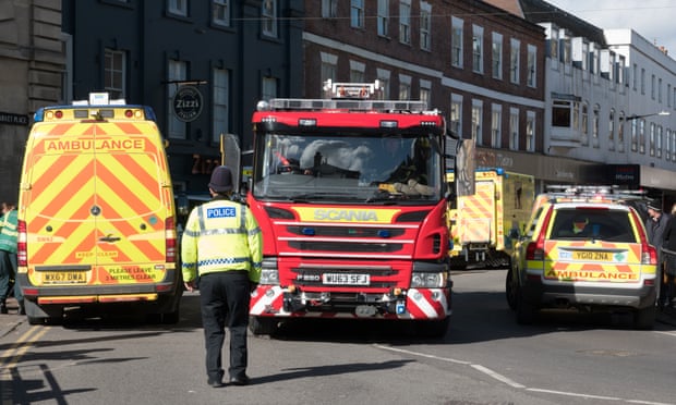 Police officers direct a fire engine outside the Zizzi restaurant in Salisbury.