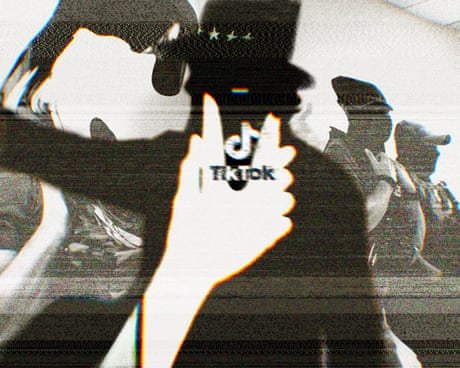 Hand in white holding phone with tiktok logo in front of dark shadow Hand in white holding phone with tiktok logo in front of dark shadow