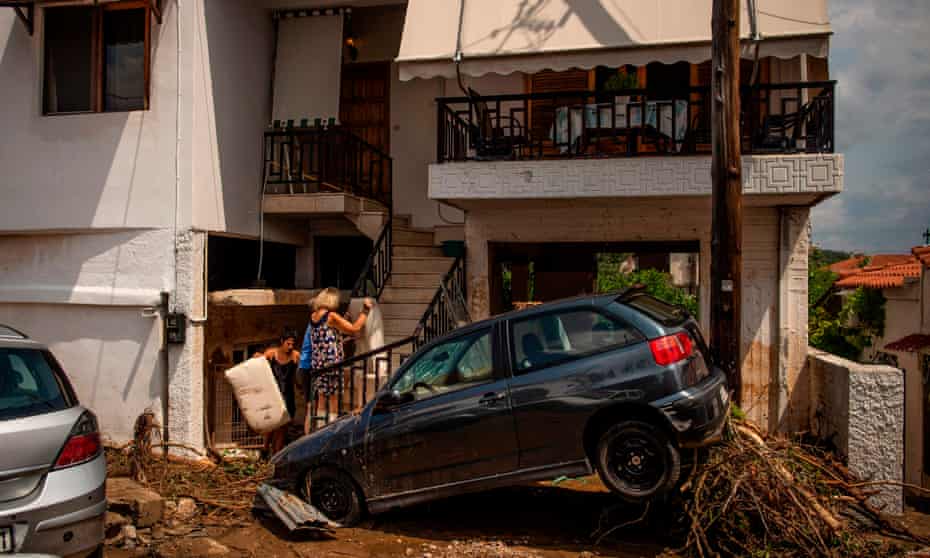 Residents clean up after floods swept through Politika, on the Greek island of Evia, killing a baby and six others. 