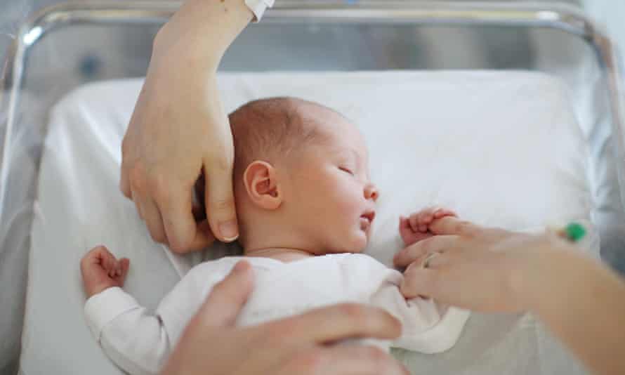 A newborn and his parents at the maternity ward