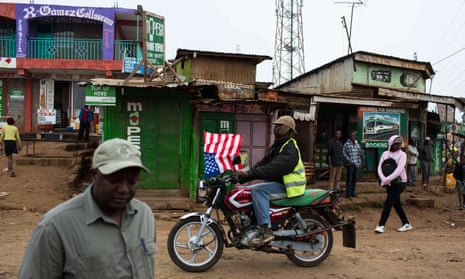 A biker passes through the Kawangware slum with an American flag during the visit of the US President Barack Obama to Kenya. An anti-corruption plan to be implemented with US assistance has gone largely unheralded by the Kenyan government.