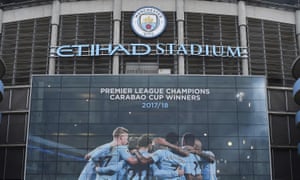 A new poster showing members of the Manchester City team celebrating has been placed at the entrance to the Etihad Stadium in Manchester, north west England to celebrate Manchester City winning the Premier League title on April 16, 2018.
Pep Guardiola's side were crowned kings of English football yesterday as their arch rivals Manchester United slumped to a shock 1-0 defeat against struggling West Bromwich Albion. / AFP PHOTO / Paul ELLIS / RESTRICTED TO EDITORIAL USE. No use with unauthorized audio, video, data, fixture lists, club/league logos or 'live' services. Online in-match use limited to 75 images, no video emulation. No use in betting, games or single club/league/player publications. / PAUL ELLIS/AFP/Getty Images