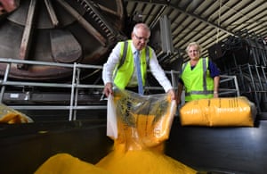 Prime Minister Scott Morrison and Nationals member for Capricornia Michelle Landry pour polymer during a visit Nu-Tank polyethylene manufacturing facility in Rockhampton, Friday, May 10, 2019.