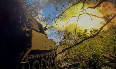 Ukrainian troops fire a self-propelled howitzer towards Russian troops in the Donetsk region