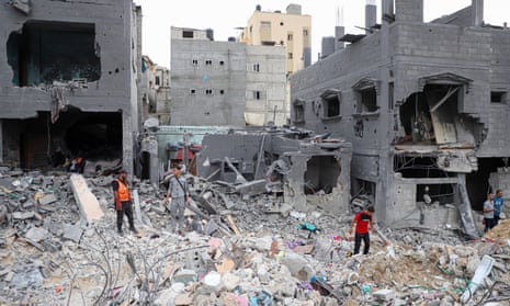 People among the rubble of buildings destroyed in Israeli airstrikes in Khan Younis, southern Gaza