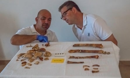 Theotokis Theodoulou and Brendan Foley examine some of the bones, which are discoloured a dark reddish-brown, possibly through age, or perhaps from the uptake of iron leached from nearby artefacts.