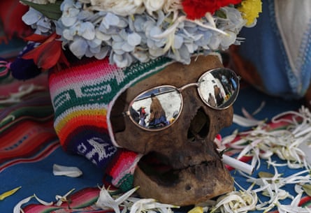 A human skull decorated with sun glasses, a hat and flowers sit on display outside the General Cemetery chapel during the annual ‘Natitas’ festival in La Pazon 8 November 2019. The celebration blends Christian and traditional indigenous customs.