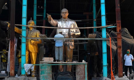 A worker polishes a bronze statue of BR Ambedkar
