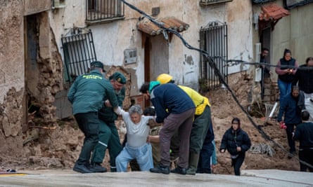Members of emergency services rescue people trapped in their homes after floods in Letur, Albacete.