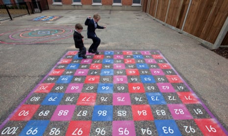 Children playing on a numbered grid in school