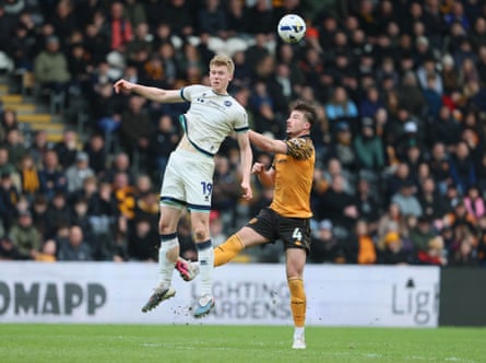 Millwall’s Josh Coburn (left) battles for the ball with Hull’s Charlie Hughes