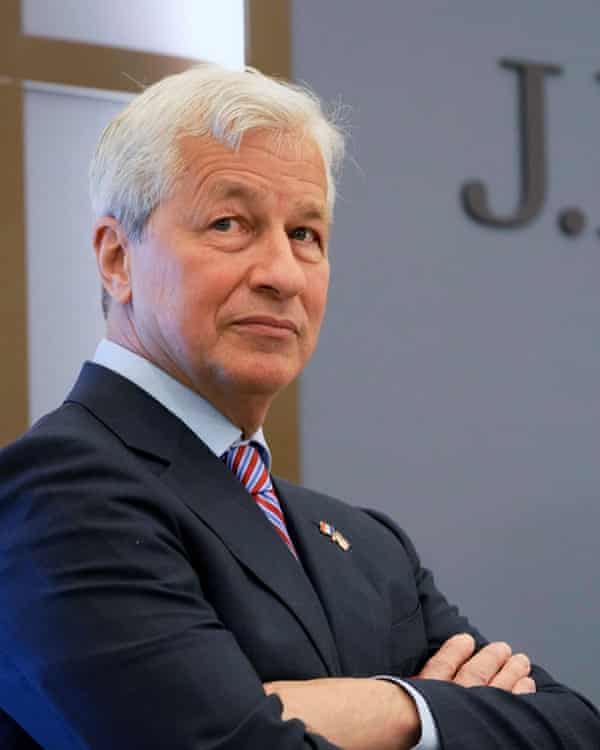 Corporate portrait of Dimon in a suit with his arms folded, turned three-quarters to the camera