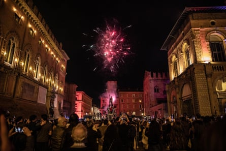 Fireworks near the statue of Neptune as Bologna supporters celebrate victory at Piazza Maggiore