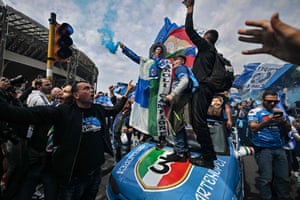 Naples, Italy: Napoli supporters cheer with colourful smoke and team flags as they assemble outside the Diego Armando Maradona stadium before the Italian Serie A football match between Napoli and Salernitana. Naples is bracing for the team to win its first Scudetto in 33 years