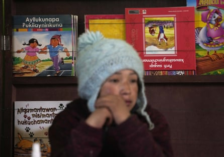 Books written in the Quechua Indigenous language sit behind a student during a class on medicinal plants, at a public primary school in Licapa, Peru, Wednesday, Sept. 1, 2021.