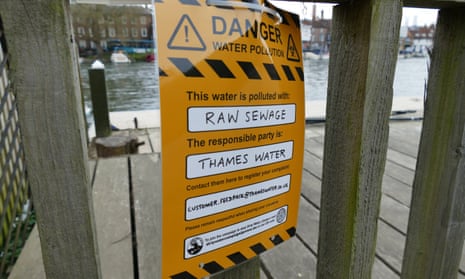 A danger sign attributes raw sewage at the start of the Henley Regatta to Thames Water.