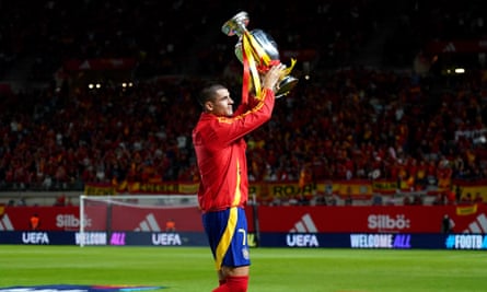 Captain Álvaro Morata parades the European Championship trophy before the game.