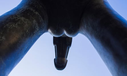 Looking up at a sculpture on display in Brno, Czech Republic. The skywards view presents an image of a penis and testicles, in bronze.