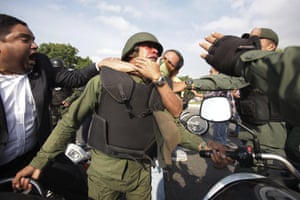 Opponents to Maduro scuffle with a Bolivarian National Guard officer who remains loyal