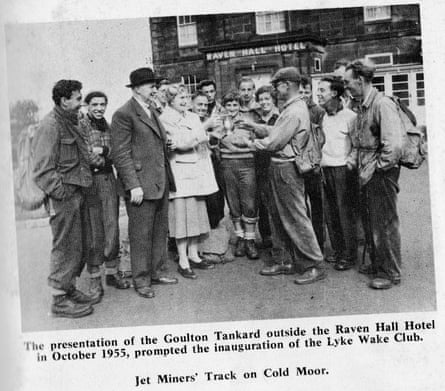 Bill Cowley (flat cap) being given a commemorative tankard in Ravenscar with the rest of the group who completed the first Lyke Wake Walk in October 1955.