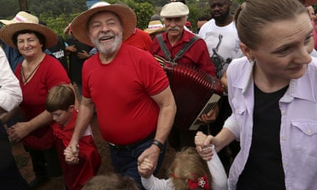 Luiz walks with supporters during a rally on a farm in Nova Erechim in southern Brazil in March. He has now taken to wearing a bulletproof vest.