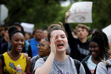 Students from South Plantation High School carrying placards and shouting slogans walk on the street during a protest, in Plantation, Florida.