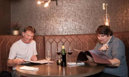 Portrait of Tony and Tom looking at menus