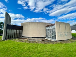 A grey church with a modernist concentric circular design