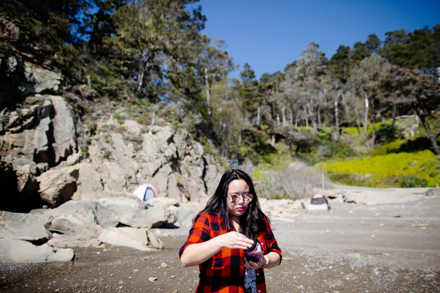 Vivian Ho, Guardian journalist and sea urchin enthusiast, eats a sea urchin at Timber Cove boat landing in Jenner, California.