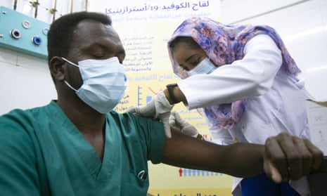 A Sudanese health worker receives a dose of Covid vaccine at Jabra hospital in Khartoum