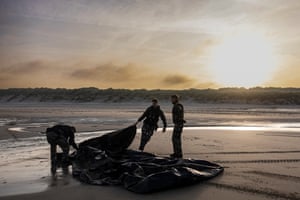 French gendarmes drag a smuggling boat as they patrol to prevent migrants from boarding smugglers’ boats off Ecault beach in Saint-Etienne-au-Mont