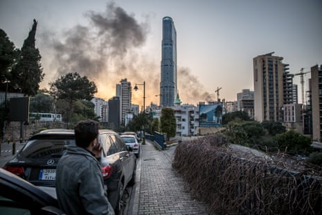 A man looks at the smoke from an Israeli airstrike in Beirut, Lebanon