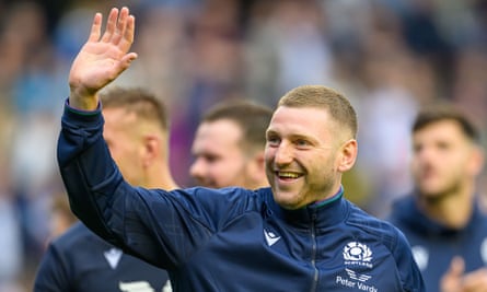 Finn Russell waves in a Scotland tracksuit