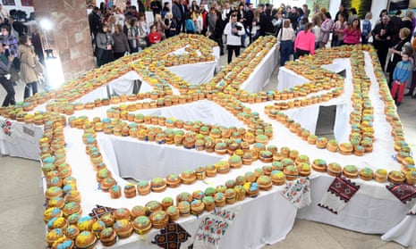 Volunteers decorate 1,000 Easter cakes in the shape of the Ukrainian coat of arms in the western Ukrainian city of Lviv