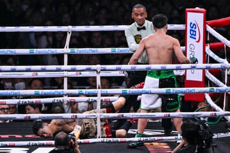 Kazuto Ioka (left) is dropped to the canvas by Takuma Inoue during their bantamweight title fight on Saturday at the Tokyo Dome.