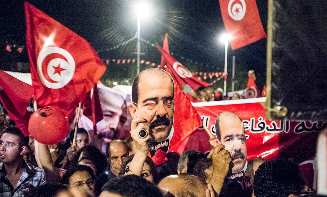 Protesters hold portraits of the slain leftwing politician Chokri Belaid in Tunis, August 2013